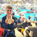 Max Hlavac winning an individual gold medal in the boys’ junior blue belt patterns category.