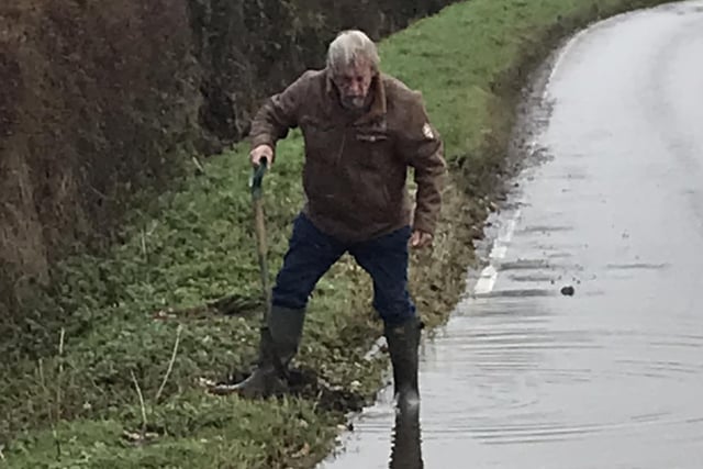 Frank Manning pictured clearing out the flood on Heyford Road.