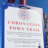 ‘Coronation Town Trail’ sign poster on board in the town centre.