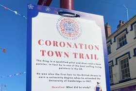 ‘Coronation Town Trail’ sign poster on board in the town centre.