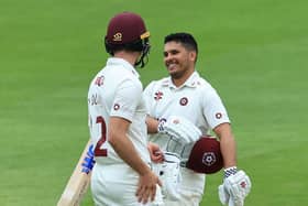 Ricardo Vasconcelos is all smiles as he celebrates reaching his century with batting partner Will Young