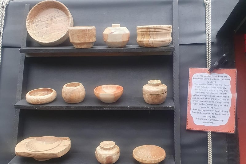 Handmade wooden items pictured, including various bowls and pots, made on board by Lloyd.