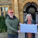 Hayley Brown pictured handing over the cheque to Keith Bunnett and Pete Spink, two Space to Talk founders and directors, on Saturday at Delapre Abbey.