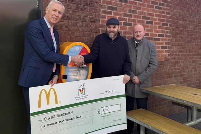 Glynn, McDonald's Franchisee, pictured handing over a contribution of £1800 for Our Jay Foundation with Geoff, McDonald's store manager).