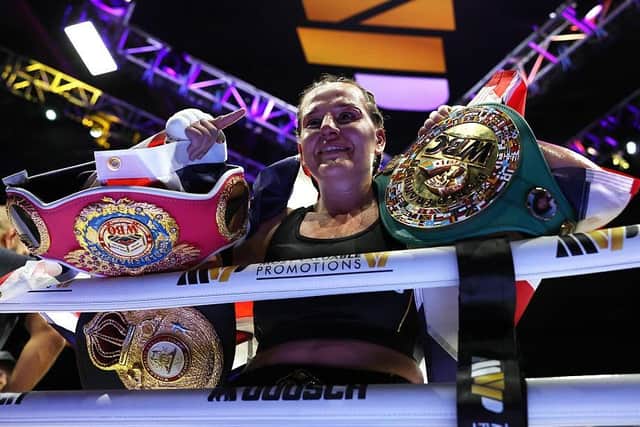 Chantelle Cameron celebrates with the title belts after victory over Mikaela Mayer in Birmingham