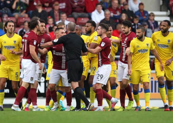 John-Joe O'Toole in the thick of the action during the Cobblers' 1-0 defeat to AFC Wimbledon at Sixfields in October