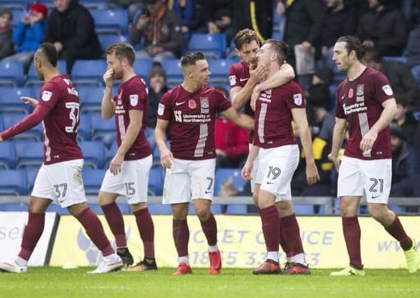 The Cobblers players celebrate Chris Long's goal in the 2-1 win at Oxford United on November