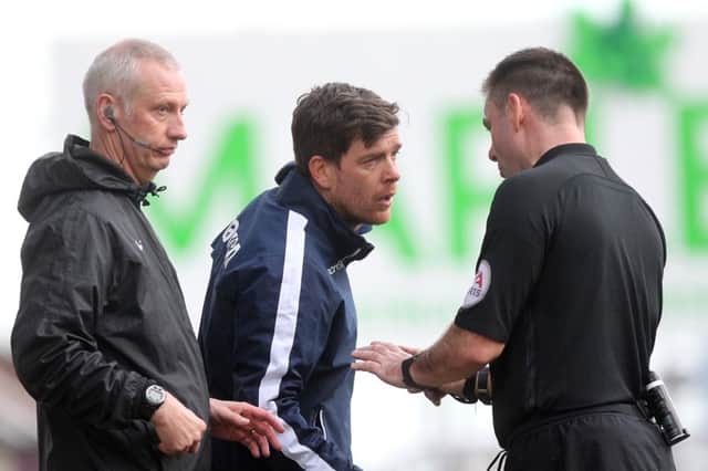 Referee Eddie Ilderton has a chat with Rovers boss Darrell Clarke