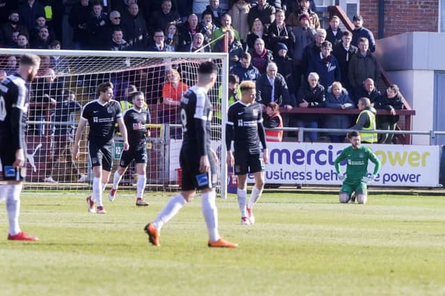 DEFLATED: Cobblers players react to Kyle Dempsey's 18th minute strike against Fleetwood on Saturday. Pictures: Kirsty Edmonds