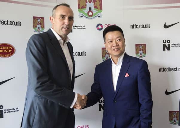 Cobblers chairman Kelvin Thomas and 5USport CEO Tom Auyeung shake hands at last year's announcement of the investment into the club by the Chinese company
