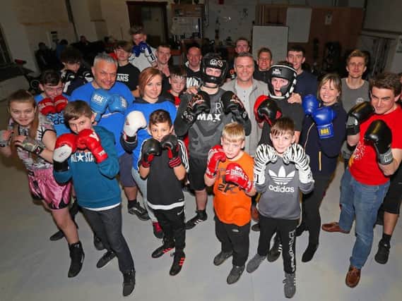 Amazon associates Jeremy Harper and Anna Szczepauiek, Arthur Budd (boxer, 15), Aaron Hill (academy coach), Brandon Smith (boxer, 14), Rachel Norris (Amazon associate) and Henry Waterfield (Amazon associate) with the rest of the members of the boxing academy