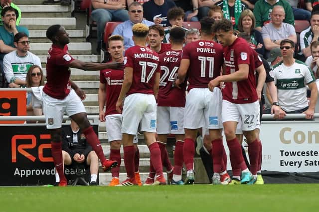 HAPPY BUNCH: Sixfields was full of smiles, on and off the pitch, during Northampton's impressive 2-0 win over Plymouth on Saturday. Pictures: Sharon Lucey