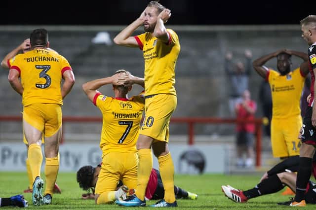 HEAD IN HANDS: Cobblers players react to one of their late missed chances at the Globe Arena on Tuesday. Pictures: Kirsty Edmonds