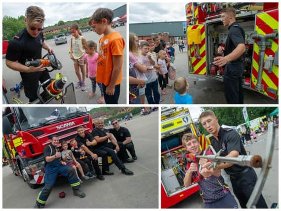 Firemen demonstrate their equipment to the children