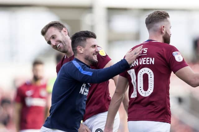 David Buchanan gives Kevin van Veen a deserved pat on the back for his work that led to Town's winning goal on Saturday. Picture: Kirsty Edmonds