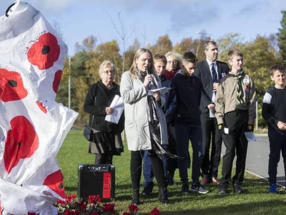 Children from the estatecreated a sheet to cover the Tommy statue,covered with painted poppies, which they all signed. 
Pictures: Kirsty Edmonds.