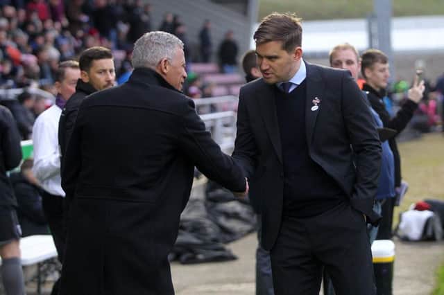 Keith Curle shakes hands with counterpart Michael Jolley before Saturday's game. Picture: Sharon Lucey
