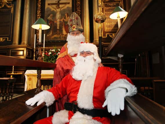 Inside the glorious All Saints Church in Northampton town centre,  St Nicholas poses with Father Christmas before the Feast of St Nick carol concert in 2010.