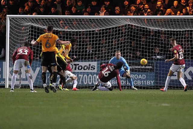 David Amoo plants his shot into the far corner to grab all three points for Cambridge. Picture: Sharon Lucey