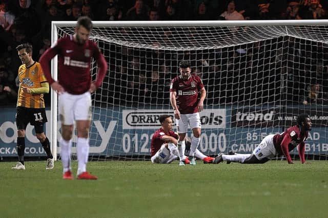 DEFLATED: Cobblers players react to Amoo's last-gasp winner. Pictures: Sharon Lucey