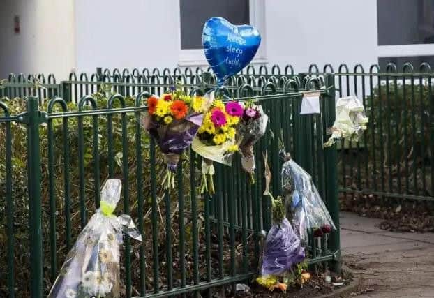 Seven bunches of flowers and a heart-shaped blue balloon were left by the railings where the incident took place.