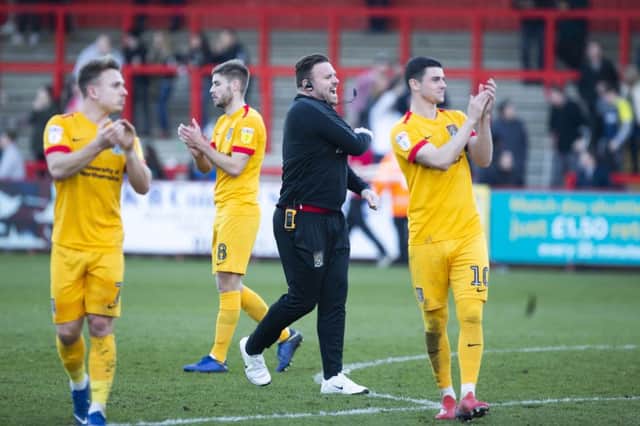 Joe Powell applauds the travelling supporters after Saturday's win at Stevenage. Picture: Kirsty Edmonds
