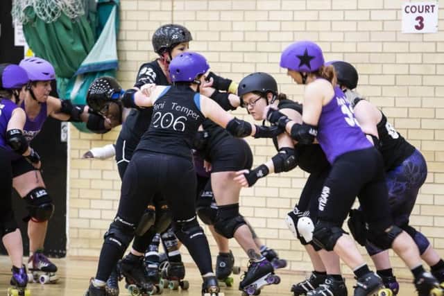A jammer (who wears a star on the helmet) attempts to get past opposing team blockers (Picture: Kirsty Edmonds)