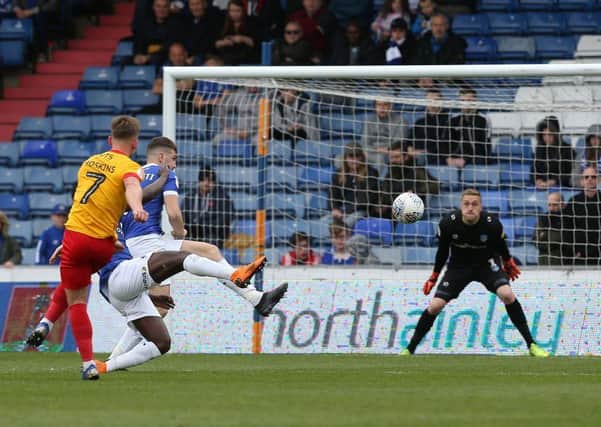 Sam Hoskins lashes into the top corner to bring Cobblers level against Oldham. Pictures: Pete Norton