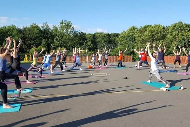 Rebecca Gartshore leading an outdoor yoga session in the sunshine in Daventry.