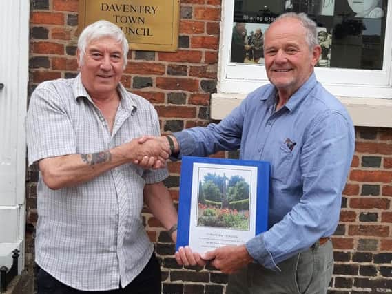 Councillor Malcolm Ogle, left, presents the First World War record to the town's mayor Mike Arnold after a recent meeting of Daventry Town Council.