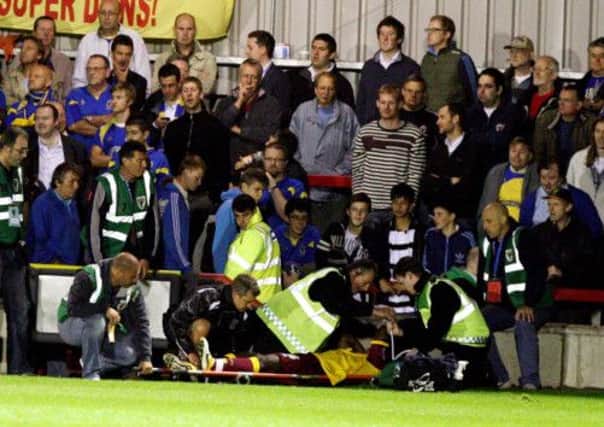 TERRIBLE MOMENT - Nana is stretchered off after getting injured at Wimbledon in September, 2011. The defender hasn't played for the Cobblers since, and will be released at the end of the current season