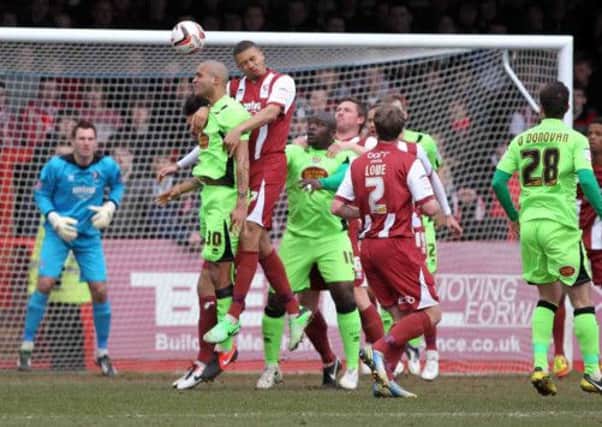 HEADS YOU WIN - Clarke Carlisle attempts to win a header during the Cobblers' defeat to Cheltenham on Saturday (pictures: Kirsty Edmonds)