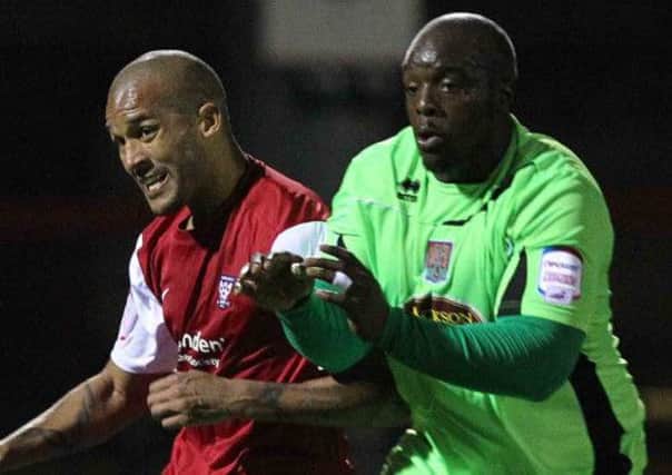 SWITCHING SIDES - Clarke Carlisle in action for York City against the Cobblers earlier this season (Picture: Sharon Lucey)