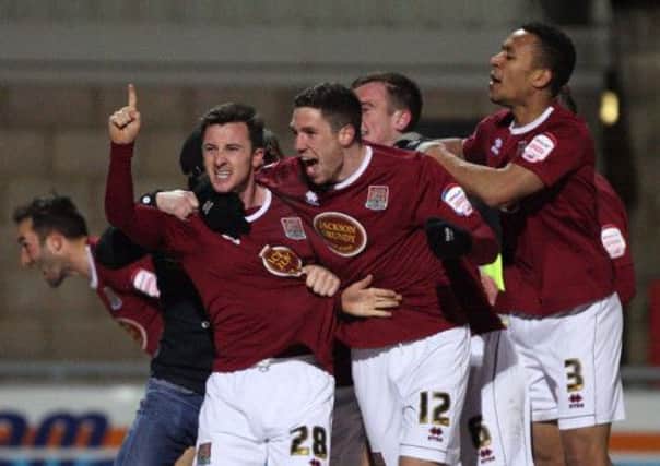 FUN-TIME - the Cobblers players celebrate Roy O'Donovan's goal that sealed the 1-0 win over Torquay on Good Friday, Town's 10th straight home win