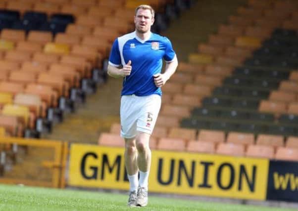 CLOSING IN ON A RETURN - Cobblers skipper Kelvin Langmead joined in the pre-match warm-up at Port Vale on Saturday (Picture: Kelly Cooper)