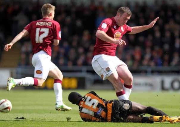 WEIGHT OFF HIS SHOULDERS - Cobblers defender Lee Collins in action against Barnet on Saturday (Picture: Kirsty Edmonds)