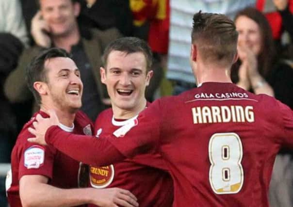 ALL SMILES - Roy O'Donovan (left) celebrates his goal against Cheltenham with Lee Collins and Ben Harding (Picture: Kirsty Edmonds)