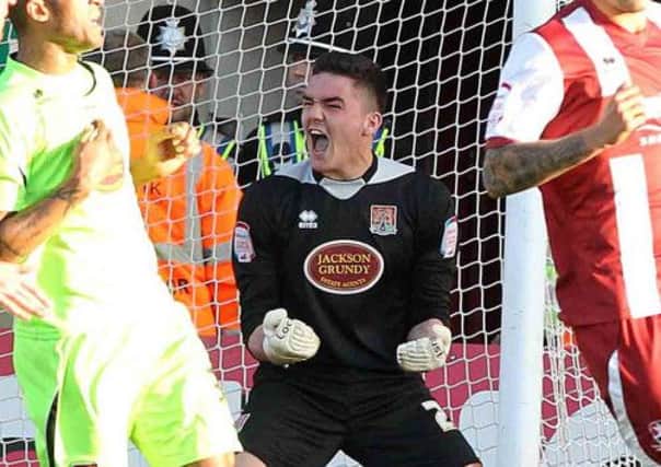 GLOVELY JUBBLY - a jubilant Lee Nicholls celebrates his penalty save at Cheltenham (Picture: Sharon Lucey)