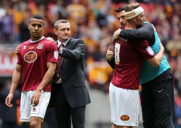 WEMBLEY WOE - Cobblers boss Aidy Boothroyd (centre) consoles Joe Widdowson (left) after Saturday's npower League Two play-off defeat to Bradford at Wembley