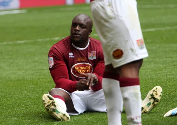 COBBLER NO MORE - Adebayo Akinfenwa sits on the Wembley turf following Saturday's play-off defeat to Bradford. He has not been offered a new deal to stay at Sixfields