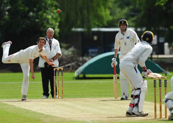IN A SPIN - Peterborough's Lewis Bruce bowls during his side's premier division draw with Finedon Dolben