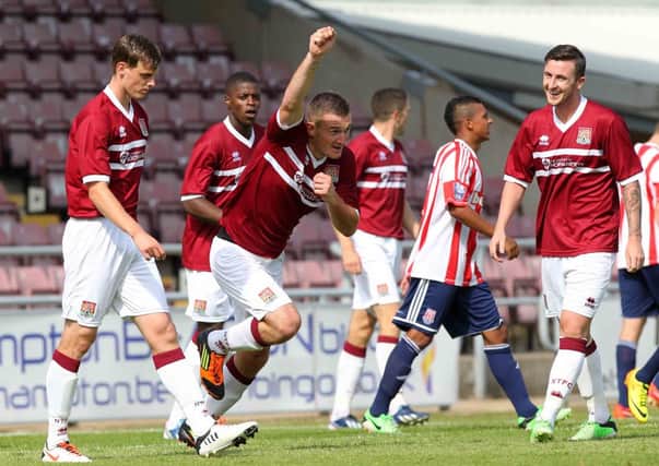 I'LL HAVE THAT! - Lee Collins tries to claim the Cobblers' second goal against Stoke, to the amusement of team-mate Roy O'Donovan (Pictures: Sharon Lucey)