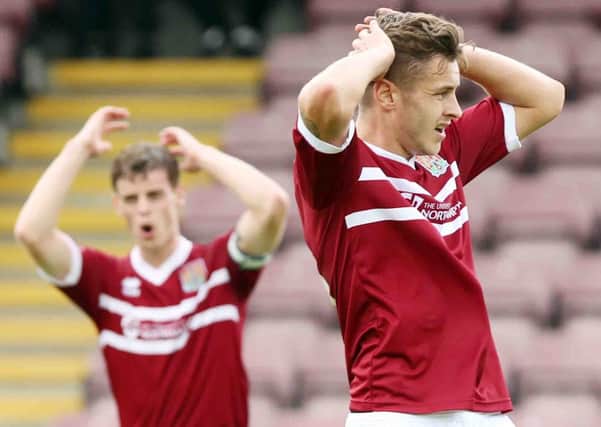 BAD DAY - Ian Morris and Jacob Blyth feel the pain as the Cobblers are beaten 2-1 by Torquay at Sixfields (pictures: Kirsty Edmonds)