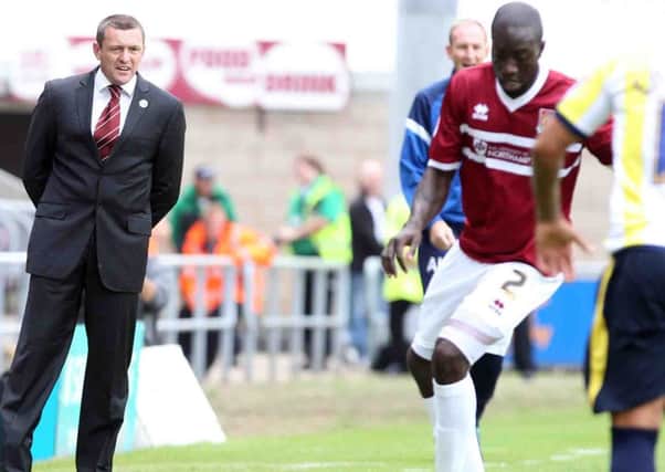 UNHAPPY VIEWING - Aidy Boothroyd watches his Cobblers team lose to Torquay on Saturday