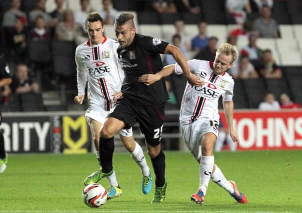 RUNNING HARD - Cobblers striker Jacob Blyth strives for an attacking opening at MK Dons (Picture: Tony Waugh)