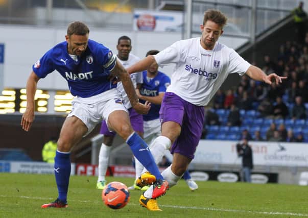 BATTLING FOR THE BALL - Daventry's Tom Lorraine tussles with Chesterfield's Ian Evatt