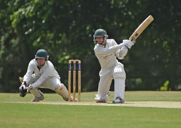 HITTING OUT - Saints' Corbyn Dolley, with Horton wicket-keeper Gary Herbert looking on, smashes a boundary on his way to 94 in his side's defeat against Horton House (Pictures: Dave Ikin)