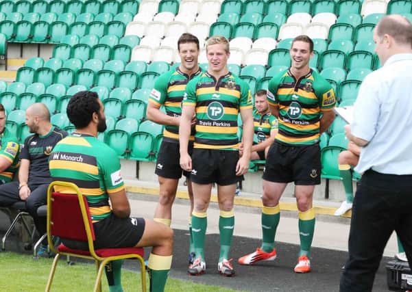 SMILE PLEASE - Glenn Dickson, Will Hooley and George North look on as Kahn Fotuali'i has his picture taken during Saints media day at Franklin's Gardens yesterday (Picture: Kirsty Edmonds)