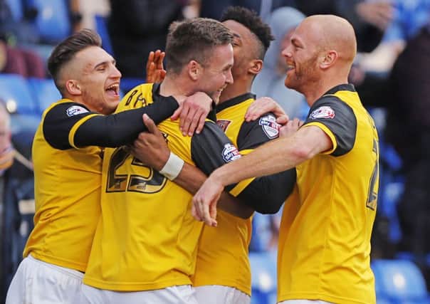 GET IN THERE - the Cobblers players celebrate Joel Byrom's strike at Shrewsbury (Picture: Kirsty Edmonds)
