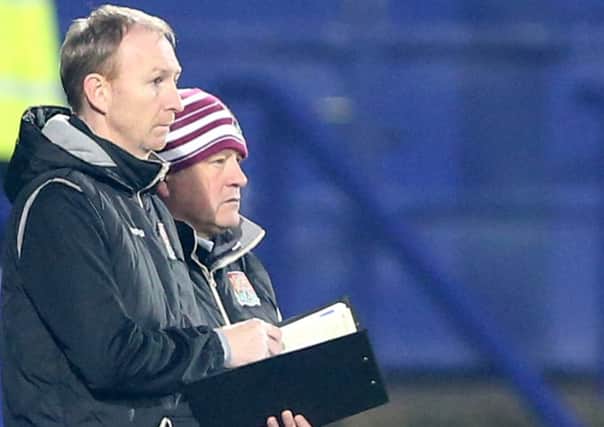 GRIM VIEWING - Cobblers boss Chris Wilder and assistant Alan Knill watch their team in the defeat at Tranmere